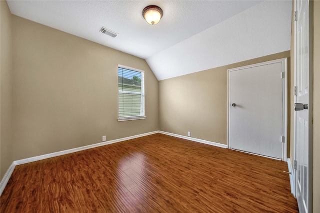 bonus room featuring lofted ceiling and wood-type flooring