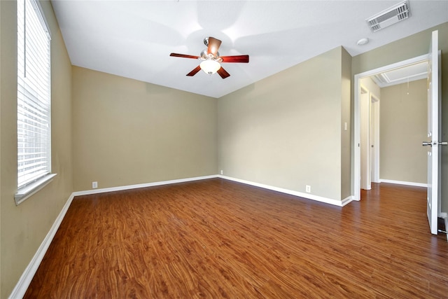 unfurnished room featuring ceiling fan and dark hardwood / wood-style flooring