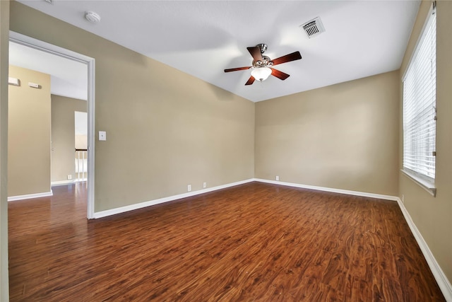 empty room featuring ceiling fan and dark hardwood / wood-style flooring