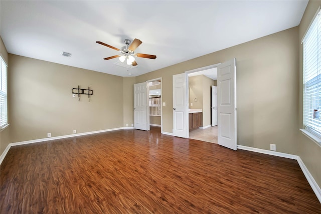 empty room with hardwood / wood-style flooring and ceiling fan