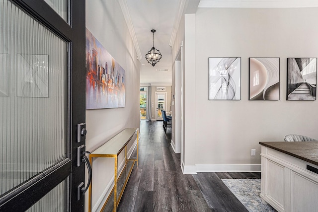 hallway with dark wood-type flooring and an inviting chandelier