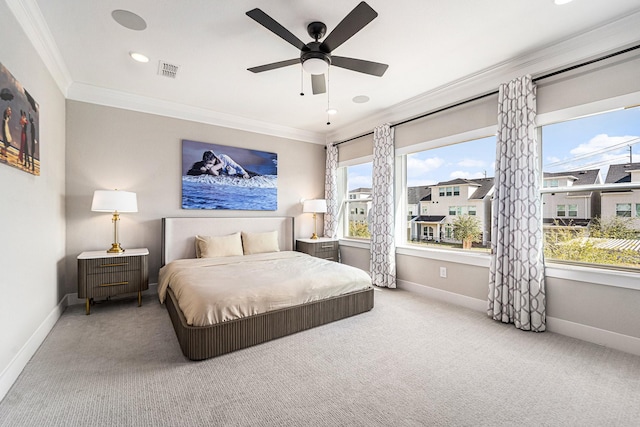 bedroom with crown molding, carpet floors, and multiple windows