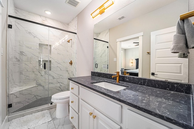 bathroom with vanity, a shower with shower door, and toilet