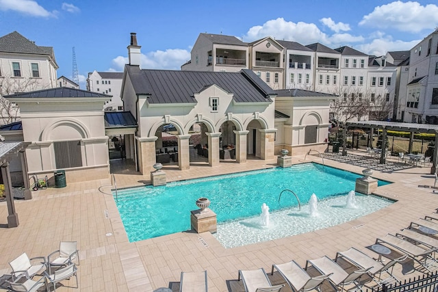 view of pool with pool water feature and a patio area