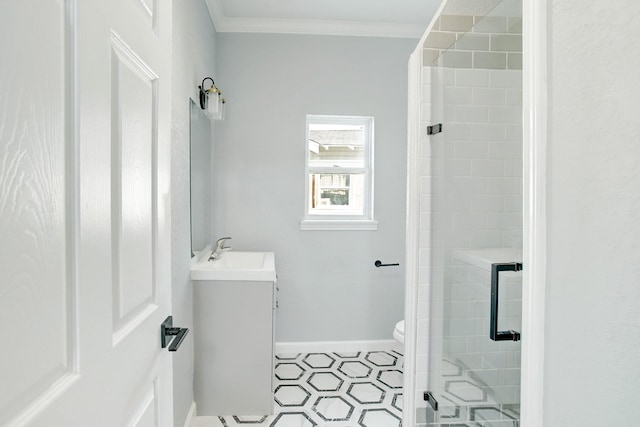 bathroom with vanity, crown molding, a shower with shower door, and toilet