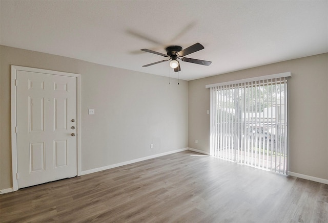 spare room with ceiling fan and hardwood / wood-style floors