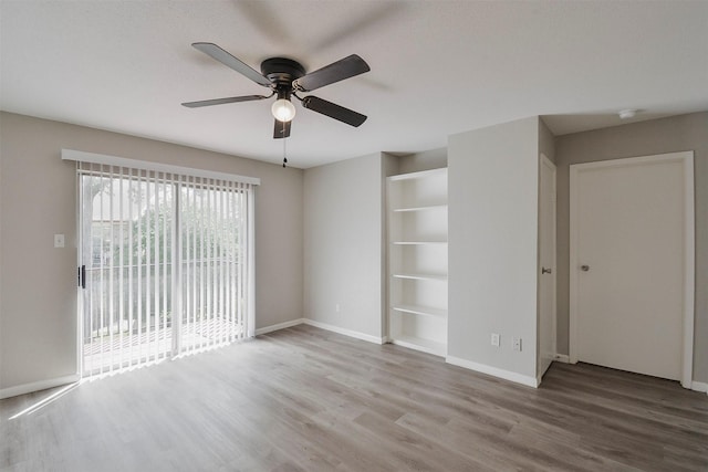 unfurnished room featuring hardwood / wood-style floors and ceiling fan