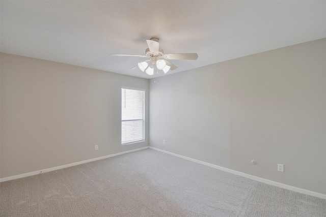 spare room featuring carpet and ceiling fan