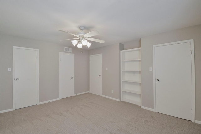 unfurnished bedroom featuring light carpet and ceiling fan