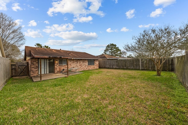 view of yard featuring a patio area and a fenced backyard