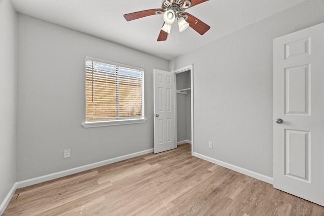 unfurnished bedroom with wood finished floors, baseboards, a closet, and ceiling fan