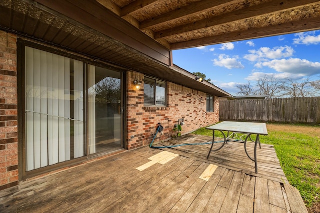 deck featuring fence and a lawn