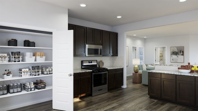 kitchen featuring dark wood-type flooring, dark brown cabinetry, stainless steel appliances, and light stone countertops