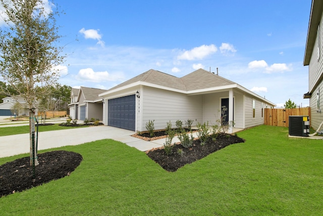 view of side of property featuring a yard, central AC unit, fence, a garage, and driveway