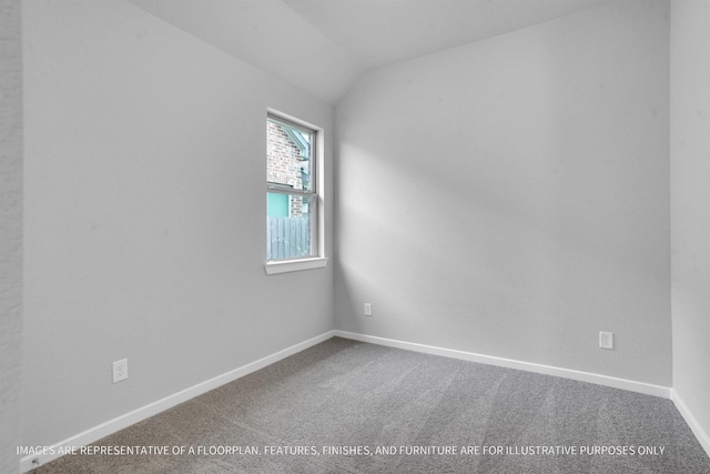 spare room featuring baseboards, carpet, and vaulted ceiling