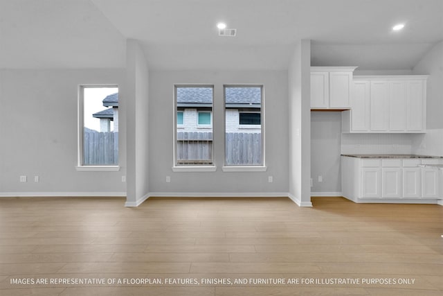 unfurnished living room with recessed lighting, visible vents, baseboards, and light wood-style flooring