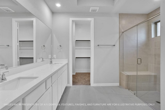 bathroom featuring a sink, visible vents, and a shower stall