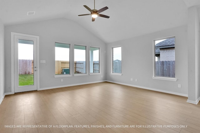 unfurnished living room with plenty of natural light, ceiling fan, lofted ceiling, and wood finished floors