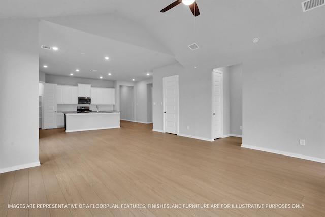 unfurnished living room featuring light wood finished floors, visible vents, baseboards, and ceiling fan