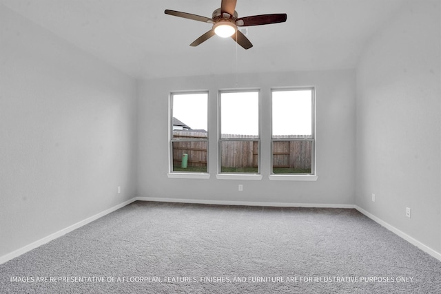 spare room with a ceiling fan, carpet, and baseboards