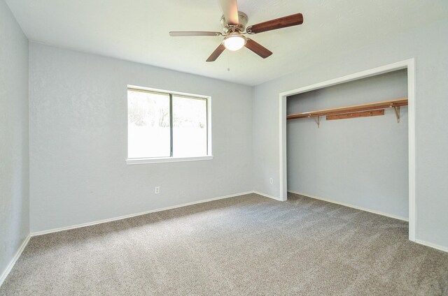 unfurnished bedroom with ceiling fan, light colored carpet, and a closet