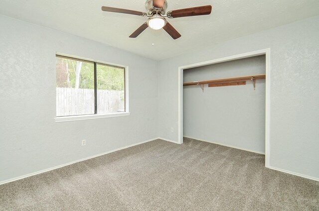 unfurnished bedroom with a closet, ceiling fan, and carpet