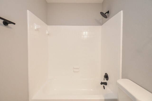 bathroom with shower / bath combination and toilet