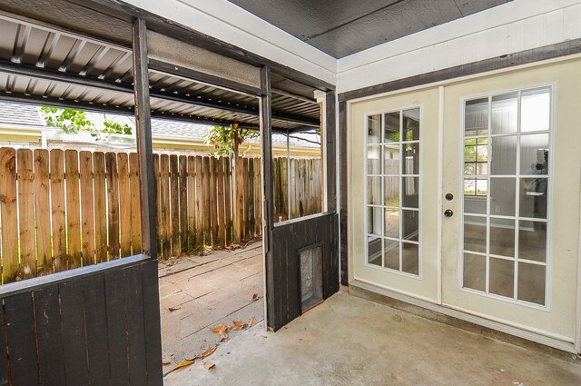 doorway featuring concrete flooring and french doors