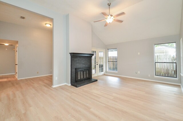 unfurnished living room with a brick fireplace, light hardwood / wood-style flooring, high vaulted ceiling, and ceiling fan