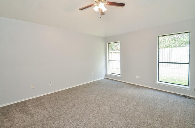 carpeted spare room with ceiling fan