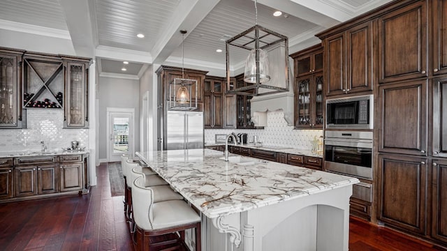 3450 Smiths Pt, Crystal Beach, TX 77650 - kitchen with sink, hanging light fixtures, black microwave, a center island with sink, and oven