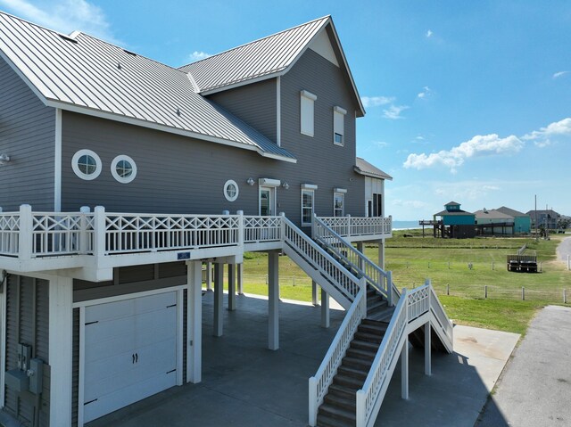 3450 Smiths Pt, Crystal Beach, TX 77650 - back of property featuring a garage and a lawn