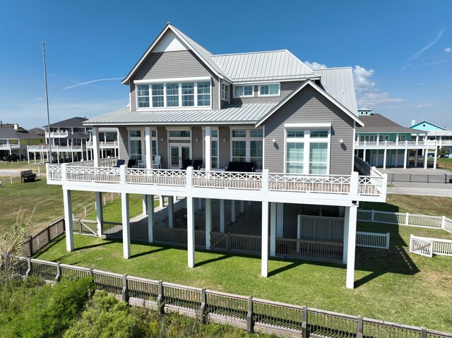 3450 Smiths Pt, Crystal Beach, TX 77650 - back of house featuring a yard and a balcony