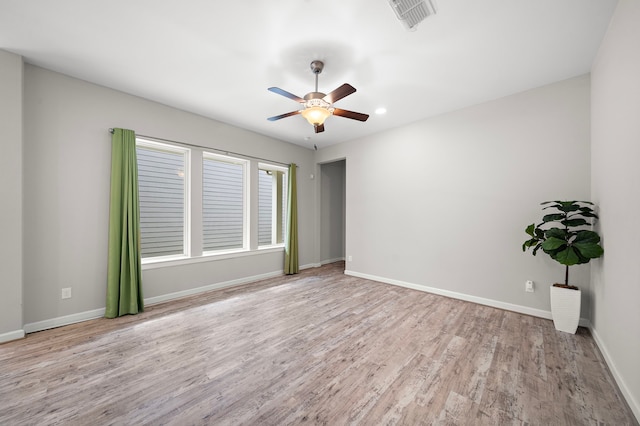 spare room featuring light hardwood / wood-style flooring and ceiling fan