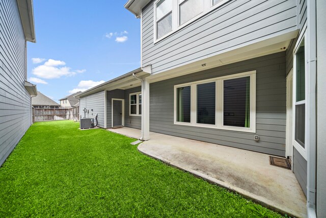 view of yard with cooling unit and a patio