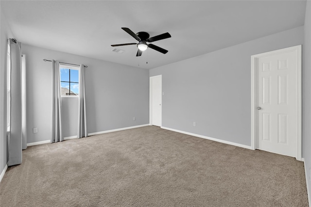 carpeted spare room with ceiling fan