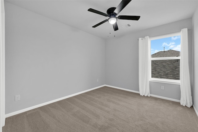 spare room featuring carpet floors and ceiling fan