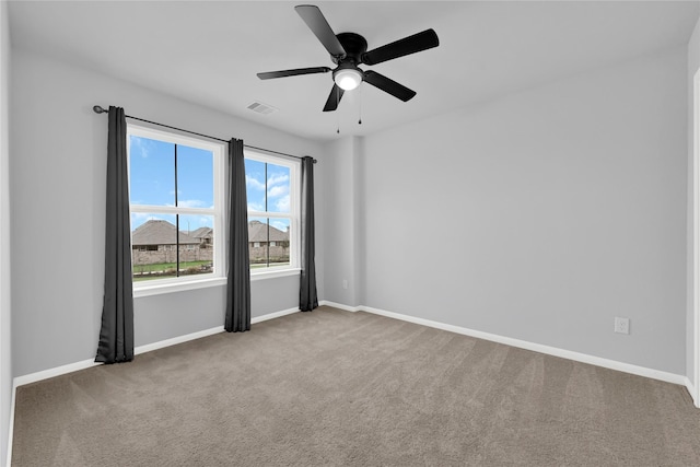 carpeted empty room featuring ceiling fan