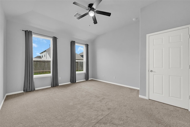 carpeted empty room featuring lofted ceiling and ceiling fan