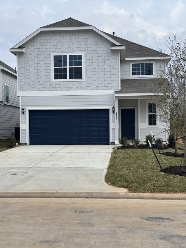 front of property featuring a garage and a front lawn