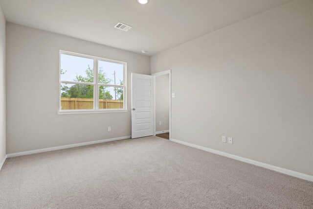 carpeted empty room with recessed lighting, visible vents, and baseboards