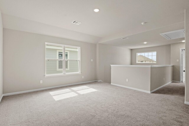 empty room featuring baseboards, recessed lighting, attic access, visible vents, and carpet