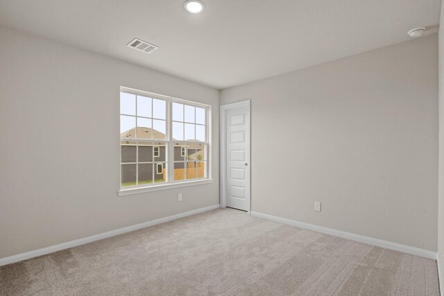 unfurnished room featuring visible vents, baseboards, recessed lighting, and light carpet