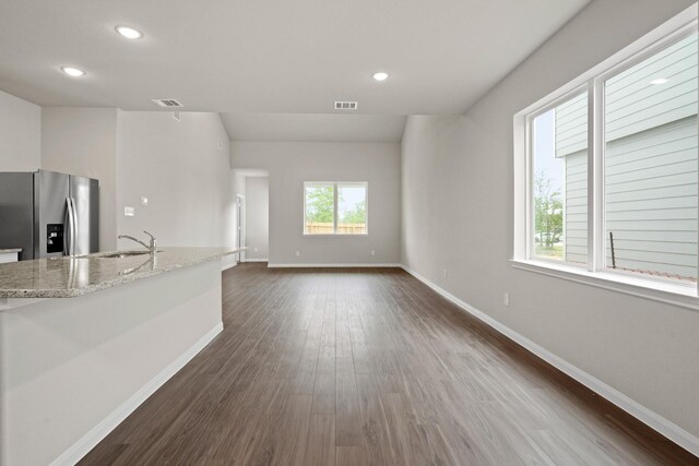 unfurnished living room featuring visible vents, baseboards, recessed lighting, and dark wood-style floors