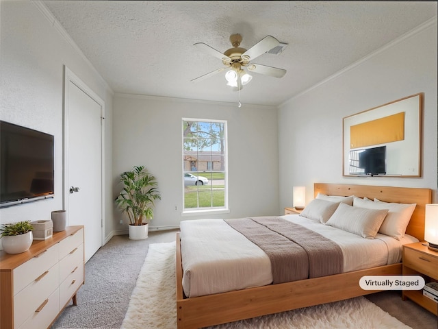 carpeted bedroom with ornamental molding, ceiling fan, and a textured ceiling