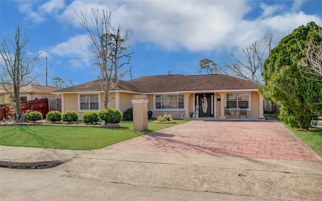 ranch-style home with a front lawn