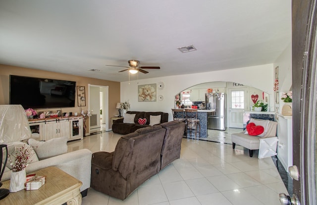 living room with light tile patterned floors and ceiling fan