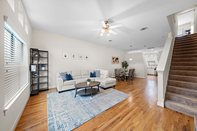 living room featuring ceiling fan and light wood-type flooring