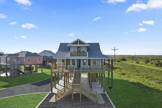 view of playground with a porch and a lawn