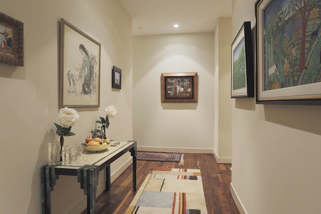 hallway with dark hardwood / wood-style flooring